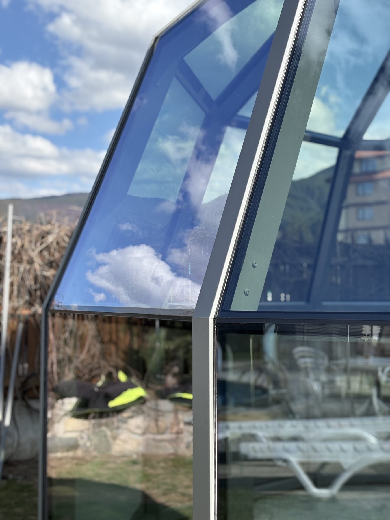 The glazing from outside: reflection by day, clear view from within