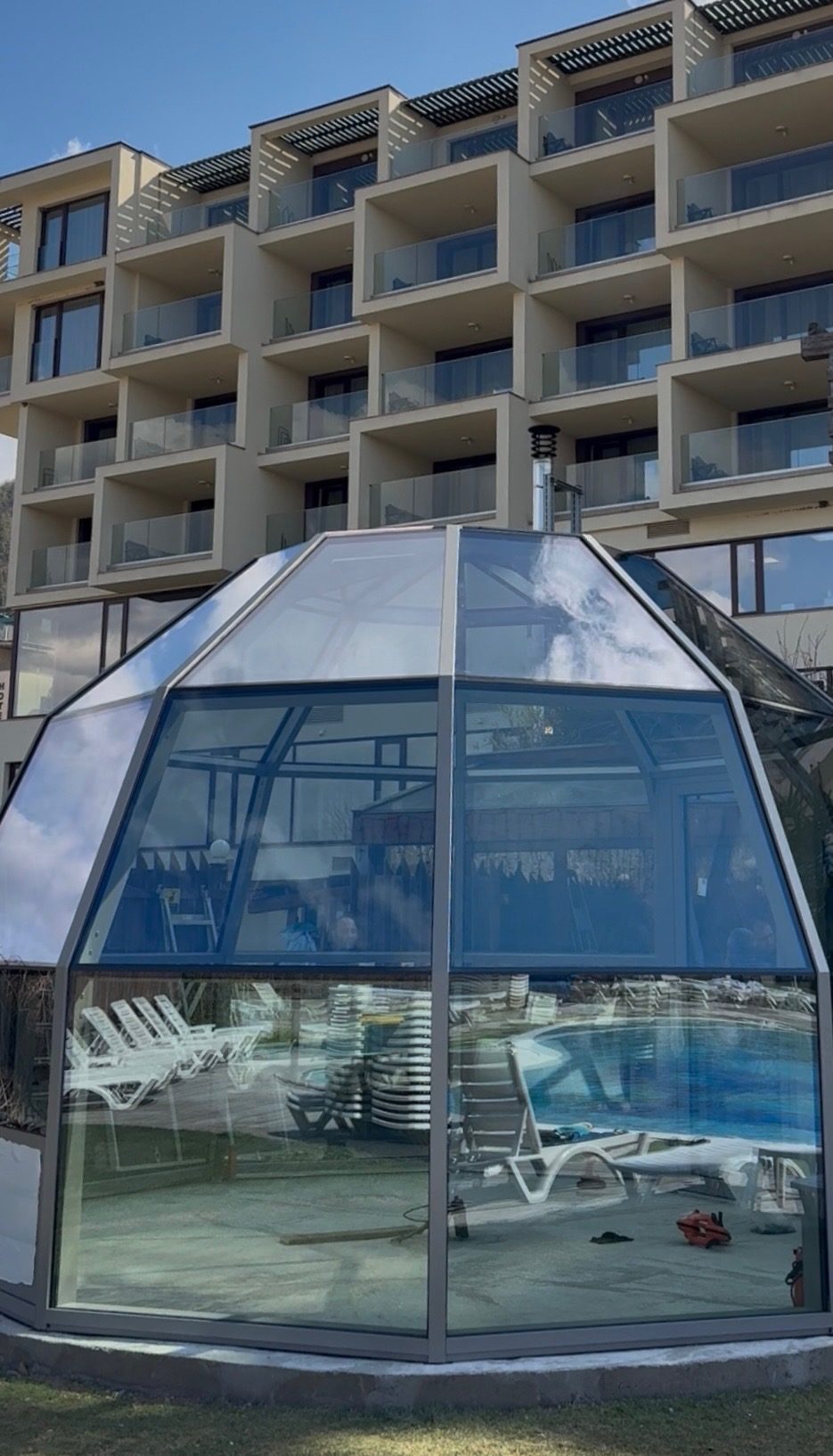 A dome beside a hotel pool: an outdoor wellness unit